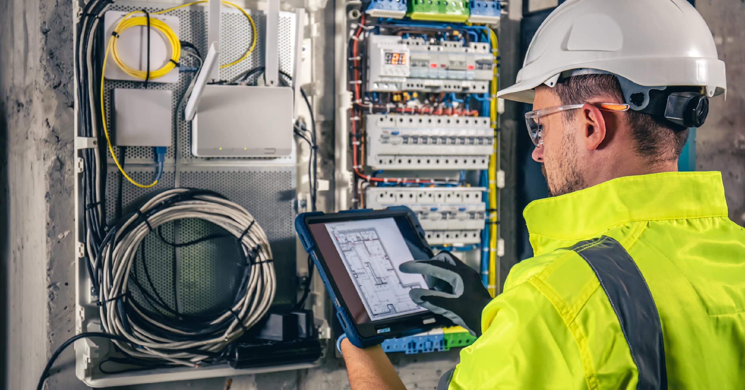 Electrical Field Service Technician Using a Field Service Management Solution on a Tablet at the Jobsite