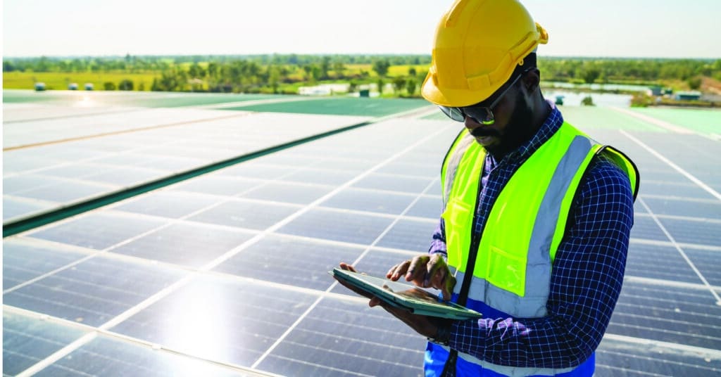 Field service technician taking notes on a solar field.